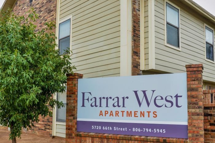 Farrar West Apartments Sign with Apartment Buildings in the Background