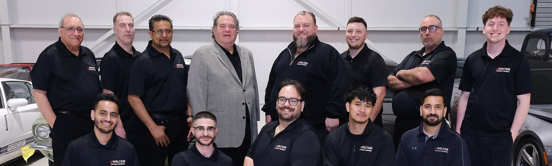 A group of men - Hamilton Team - are posing for a picture in a garage. | Halton Auto Service & Transmission