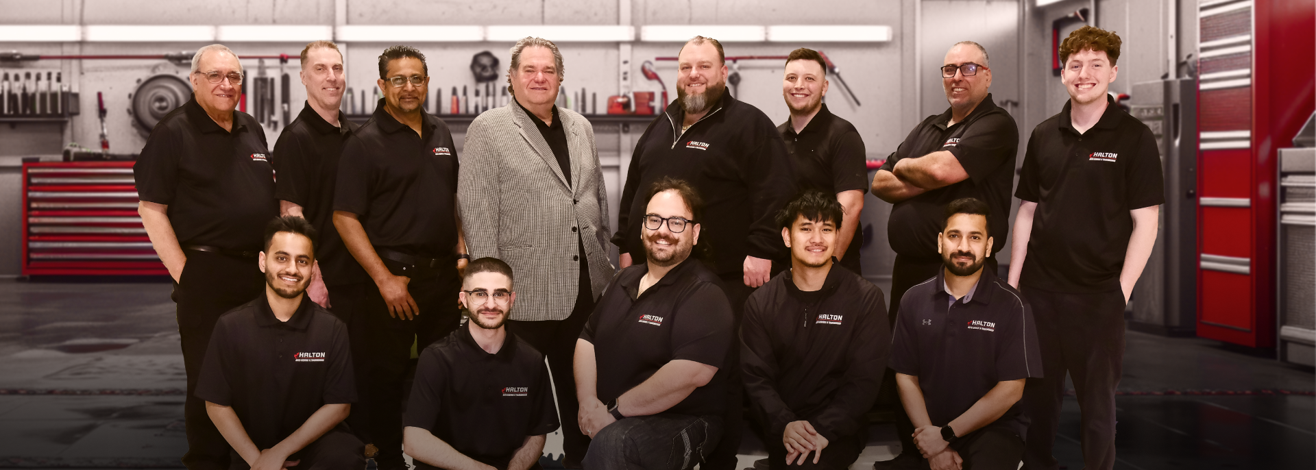 A group of men are posing for a picture in a garage. | Halton Auto Service & Transmission