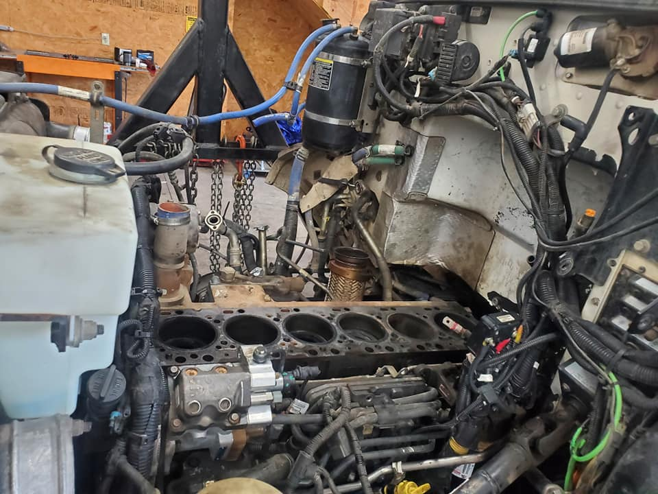 A close up of a car engine with a lot of wires coming out of it