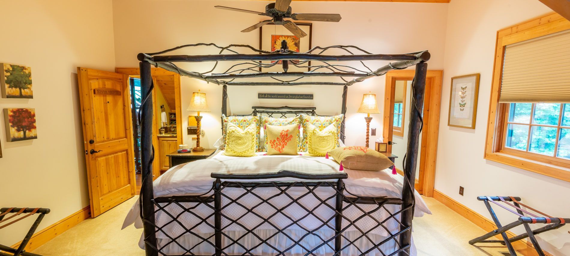 A bedroom with a canopy bed and a ceiling fan.