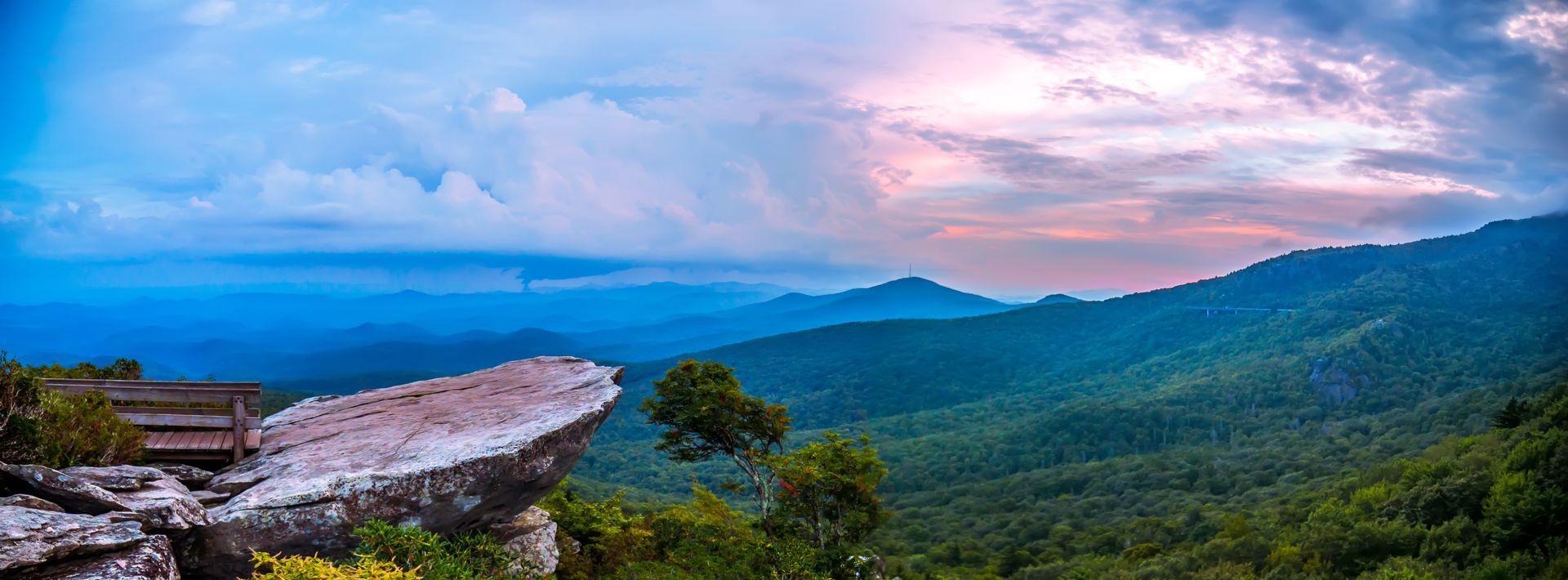There is a large rock in the middle of the mountains.