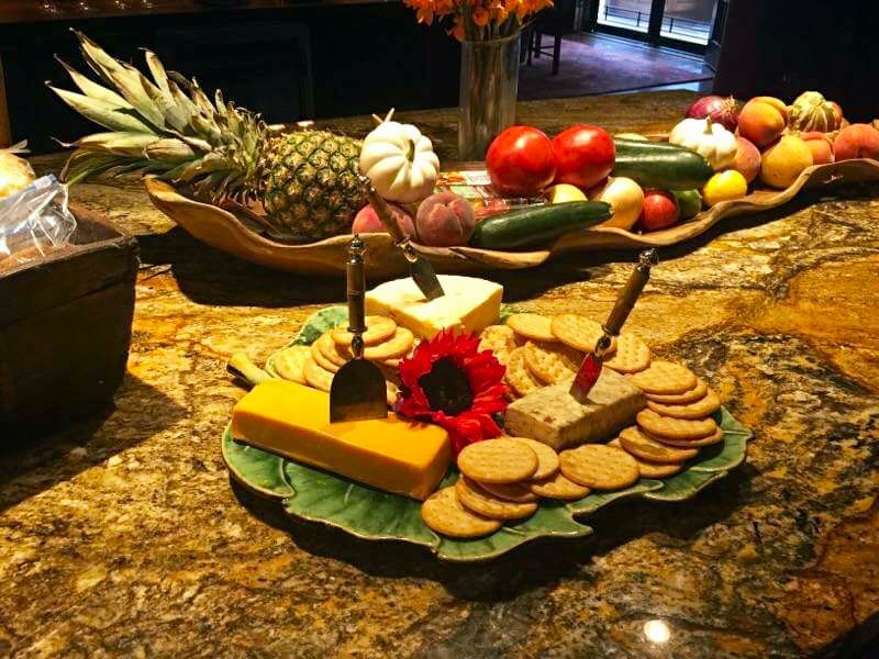 A leaf shaped plate with cheese and crackers on it