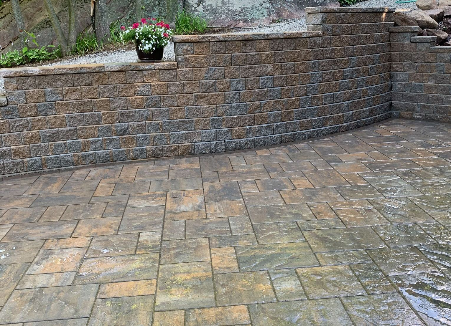 Finished patio with interlocking pavers and retaining wall highlighting clean lines and durable hard