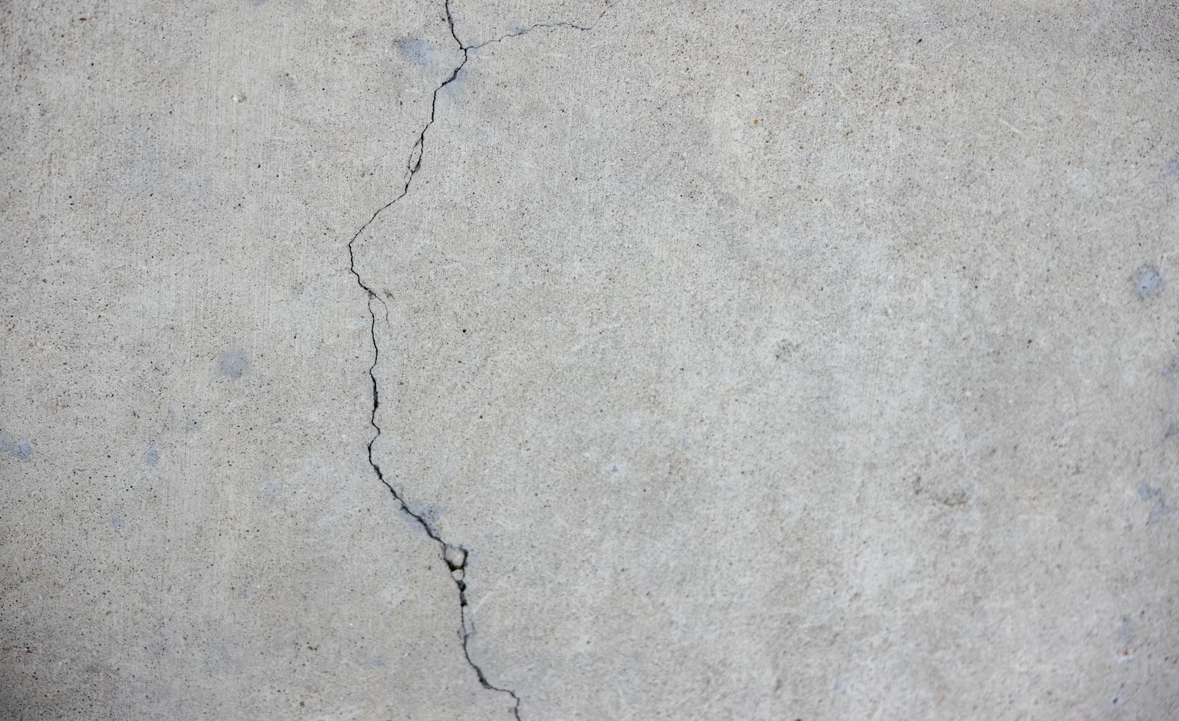 Interlocking patio with visible settlement and cracking caused by poor base preparation and drainage