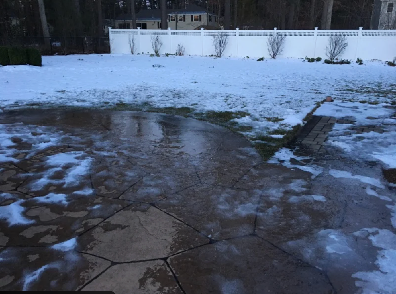 Spring yard inspection showing patio shifting, lawn damage, and drainage issues after winter thaw