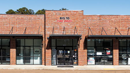 a brick building with a sign that says big 10 take away