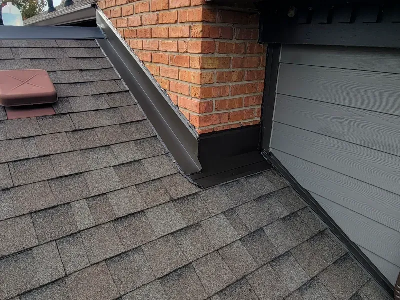 A roof with shingles and a chimney on it