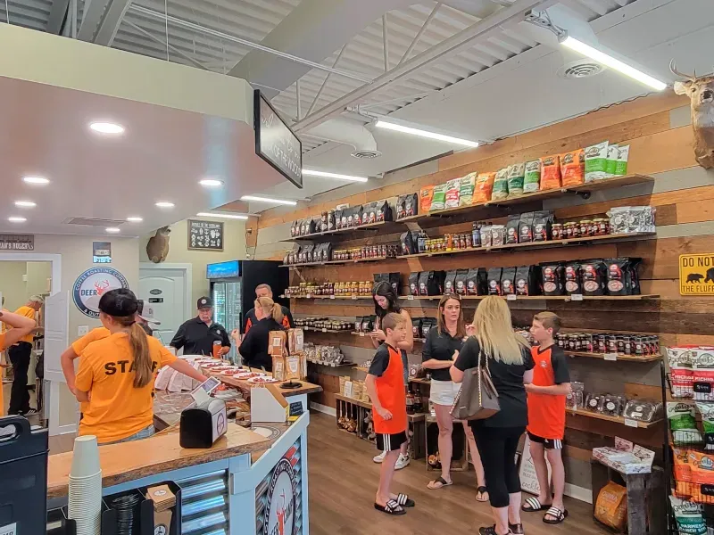A group of people are standing around a counter in a store.