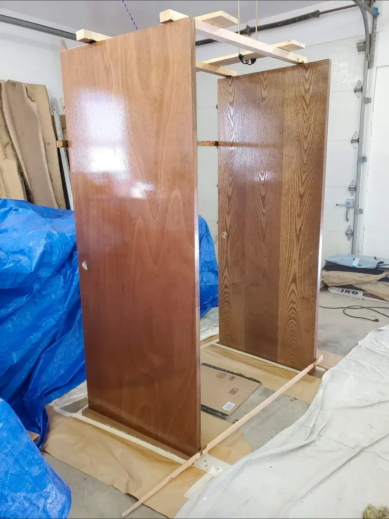 A wooden cabinet is being built in a garage