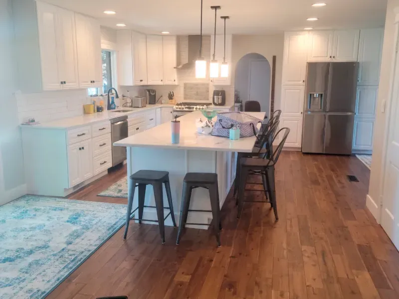 A kitchen with white cabinets and stainless steel appliances