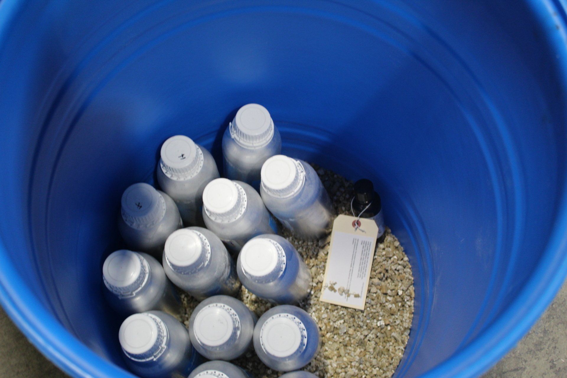 Elk's lab chemist packs expired chemicals in a 55-gallon drum. 