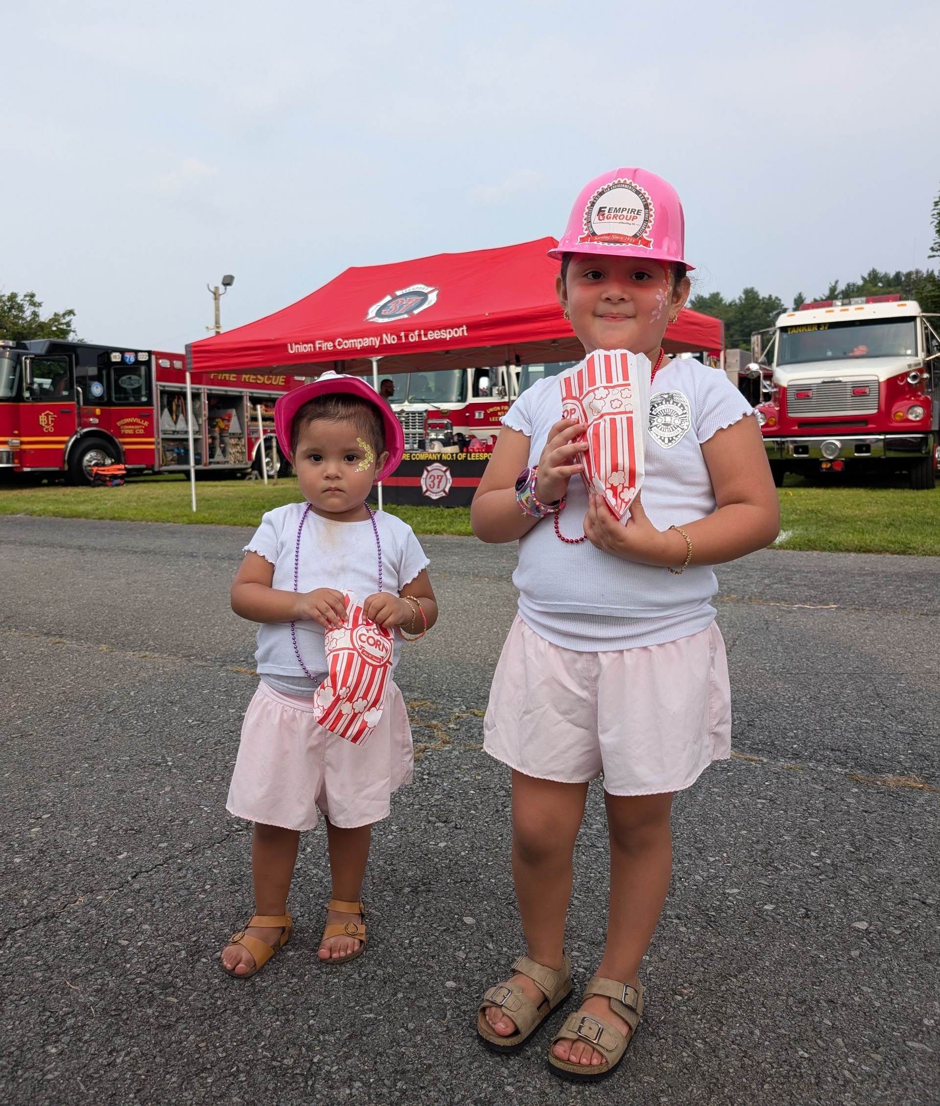 Kids wearing Empire Group hard hats at National Night Out.