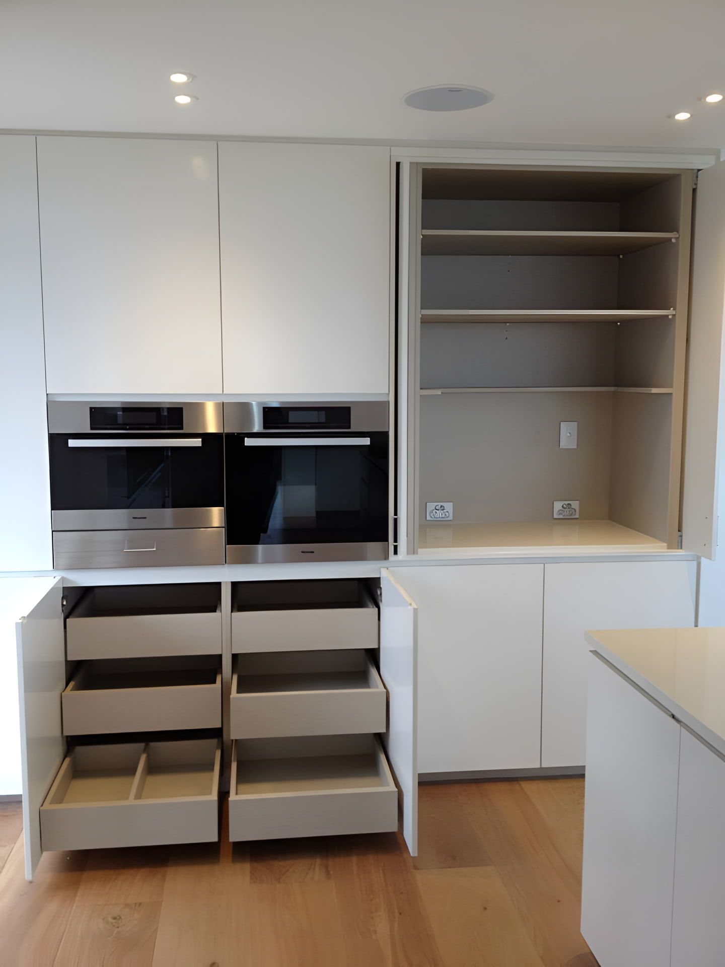 A Kitchen With Stainless Steel Appliances And White Cabinets — North Coast Cabinets In Byron Bay, NSW
