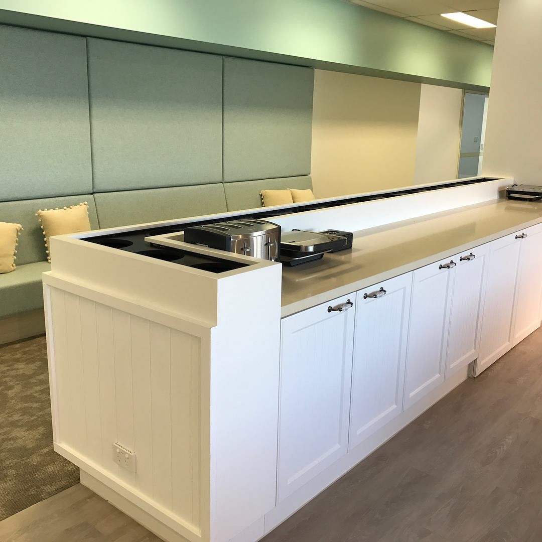 A Kitchen With White Cabinets And Stainless Steel Appliances — North Coast Cabinets In Ballina, NSW