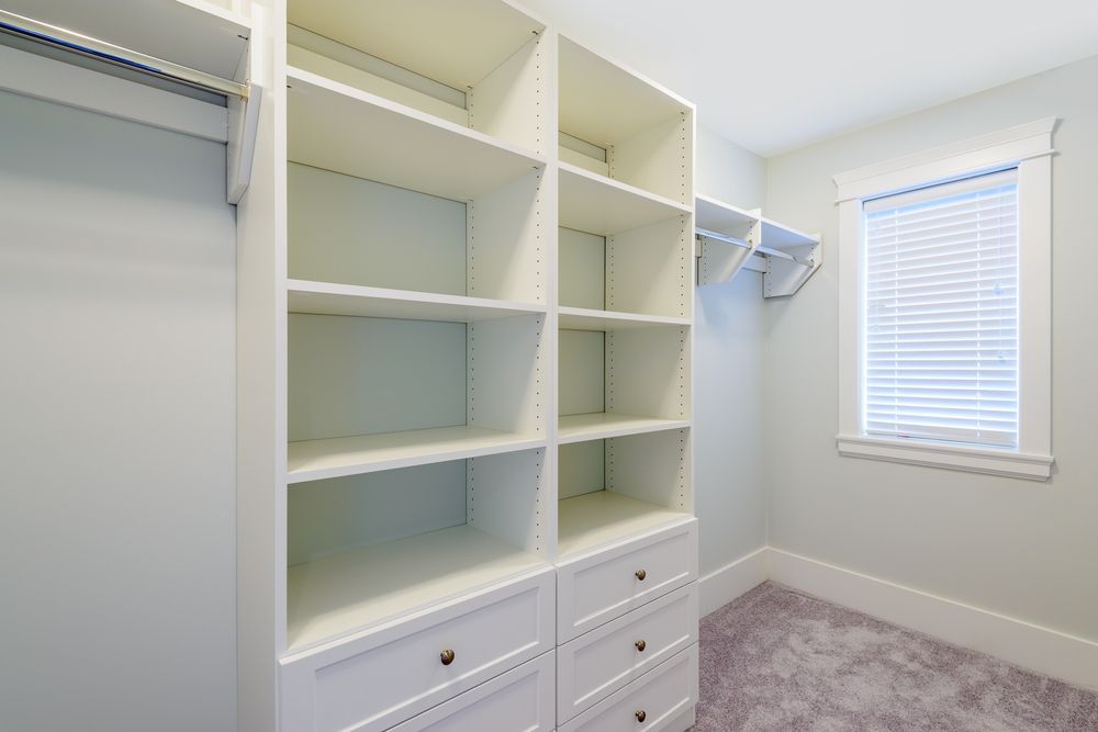 A Walk In Closet With Lots Of Shelves And Drawers And A Window — North Coast Cabinets In South Lismore, NSW