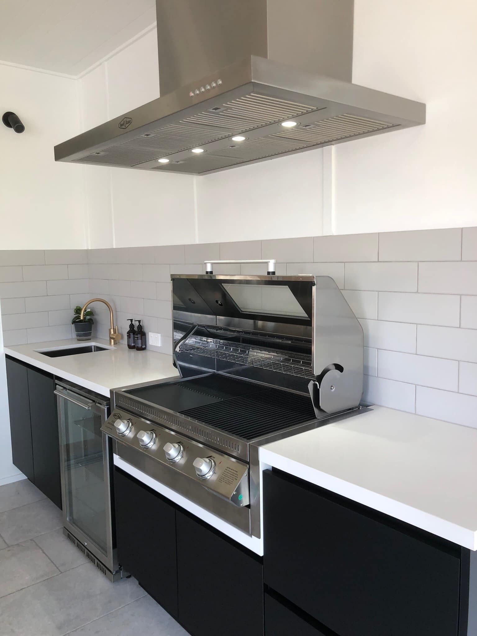 A Kitchen With A Grill And A Hood Above It — North Coast Cabinets In South Lismore, NSW