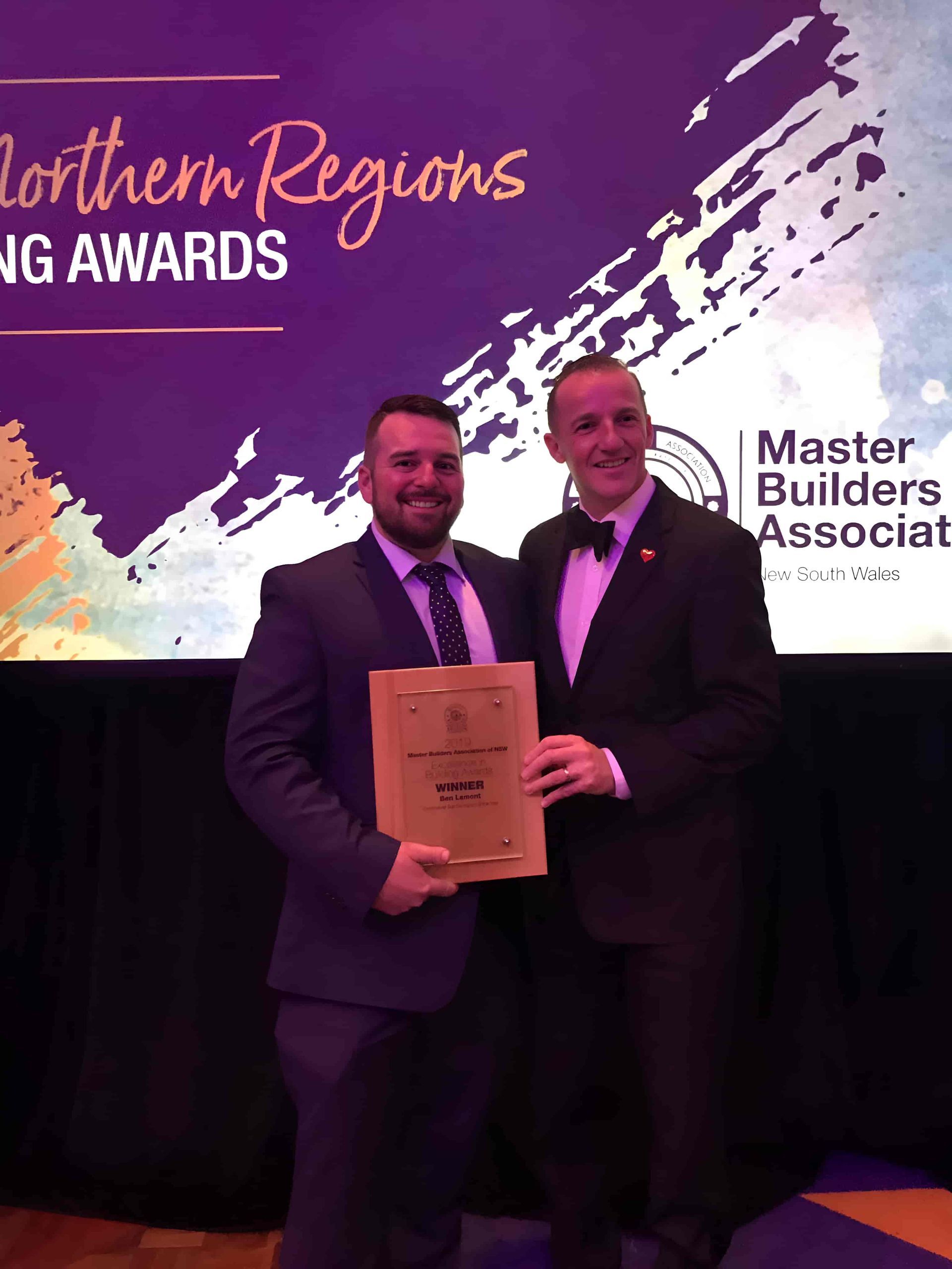Two Men In Suits Are Standing Next To Each Other Holding A Certificate — North Coast Cabinets In South Lismore, NSW