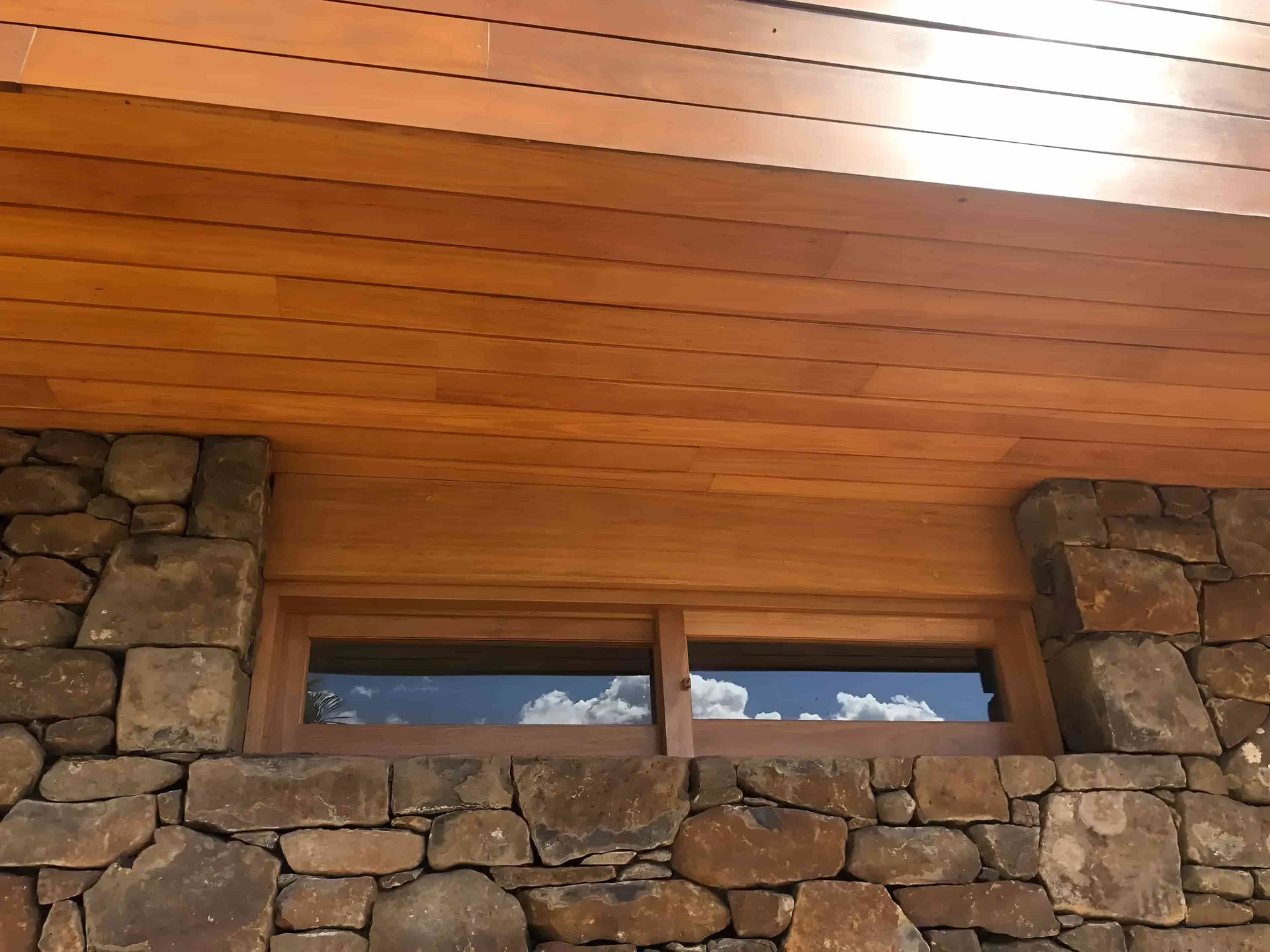 A Stone Wall With A Window And A Wooden Ceiling — North Coast Cabinets In Lismore, NSW