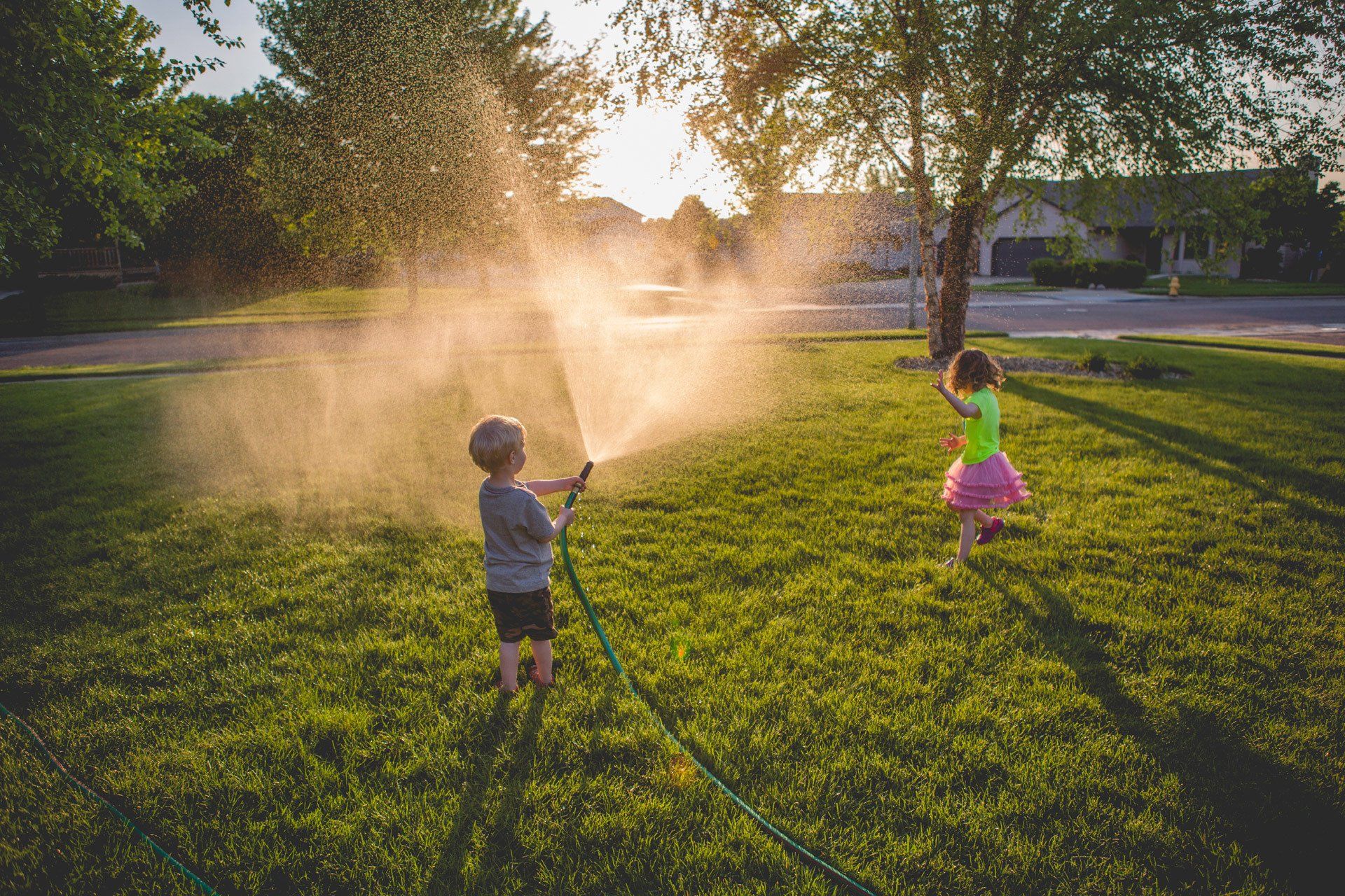 Kids playing with a hose