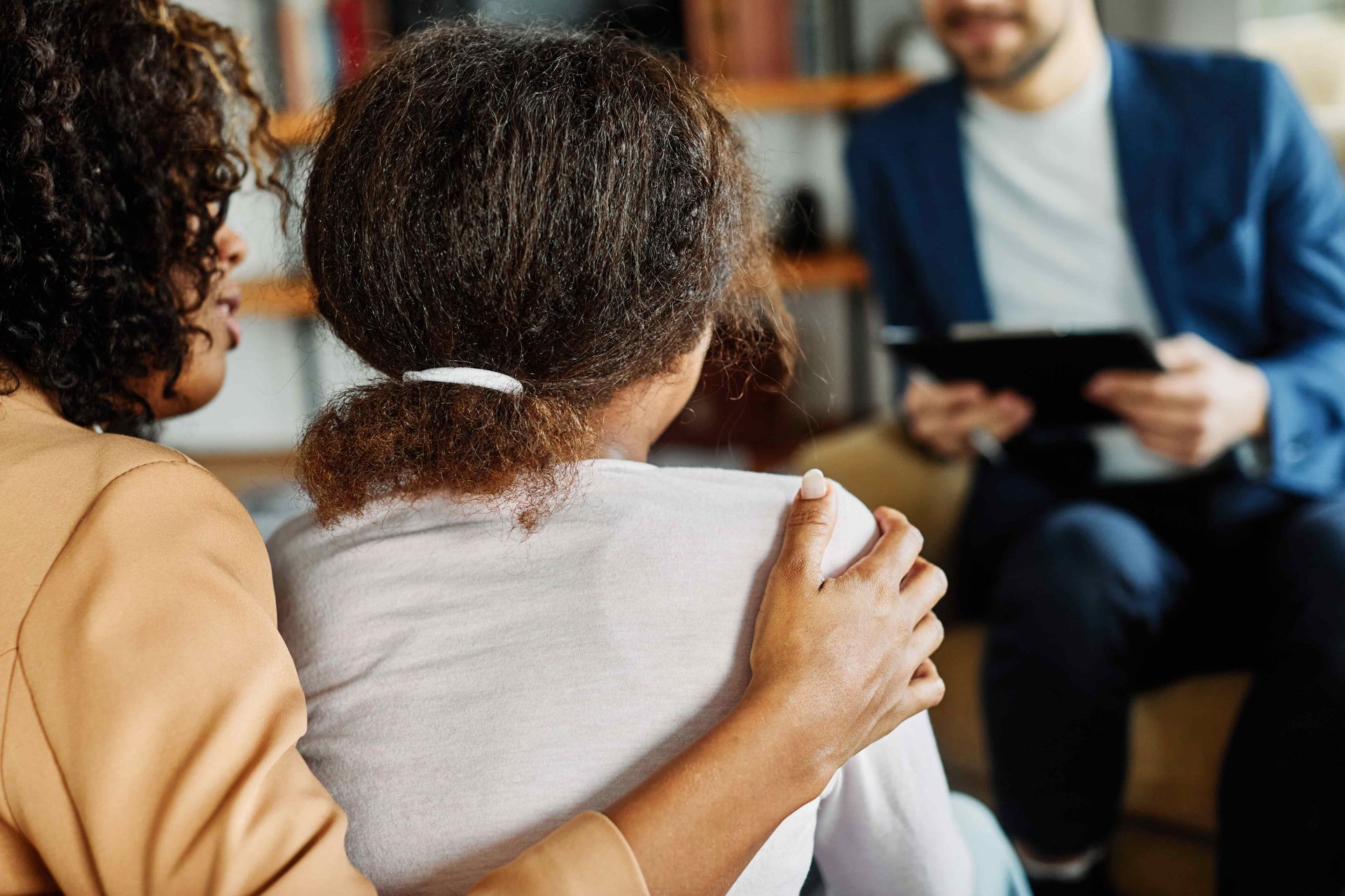 Mother with her teenage daughter at meeting with the psychiatrist.