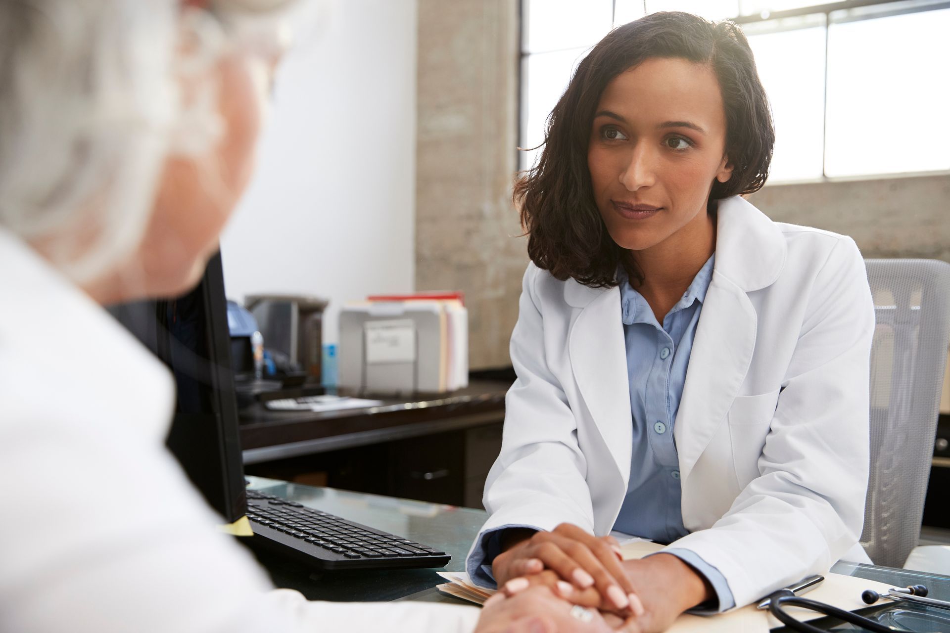 A young female psychiatrist in a consultation with a senior patient