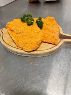 Chicken schnitzel on a board — Wattle Butchery In Cootamundra, NSW