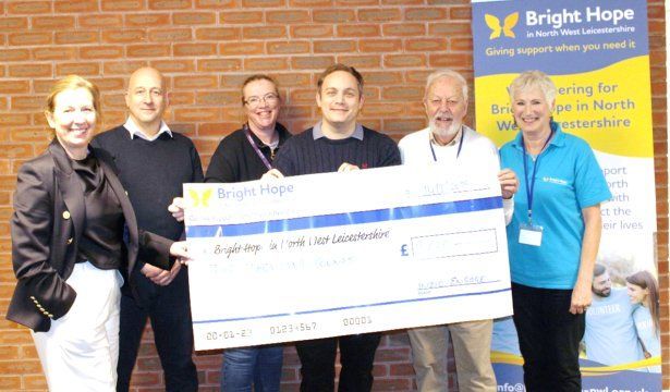 Group holding an oversized check for 