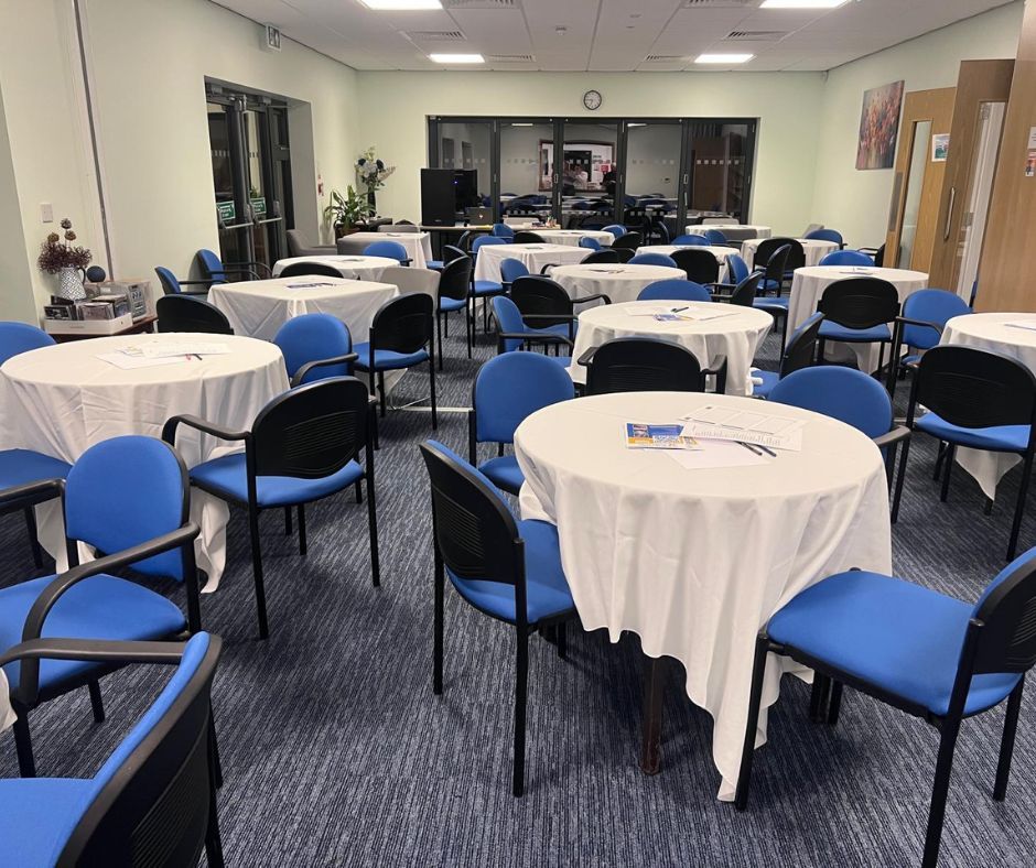Bright room with blue armchairs, a brown armchair, and a doorway to an outdoor patio.