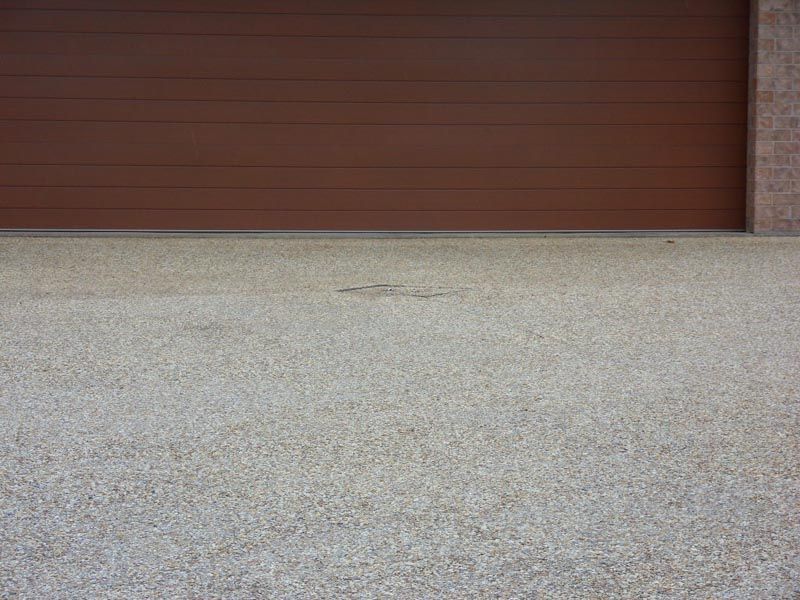Close-up of a Garage Door & Driveway — Coffs Harbour, NSW — Coolamon Concrete Tanks