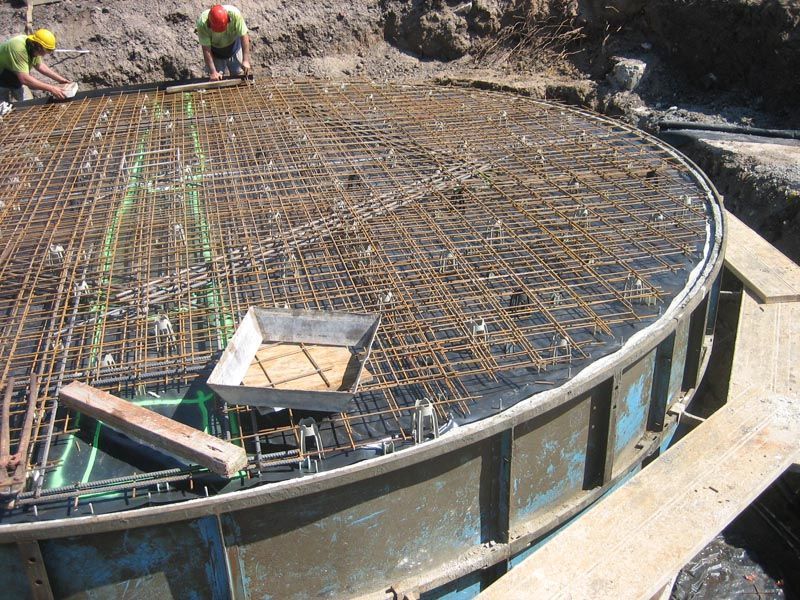Person Working on a Large Rainwater Tank — Coffs Harbour, NSW — Coolamon Concrete Tanks