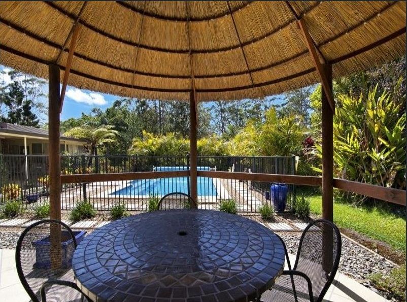 Patio with a Thatched Roof and a Table — Coffs Harbour, NSW — Coolamon Concrete Tanks