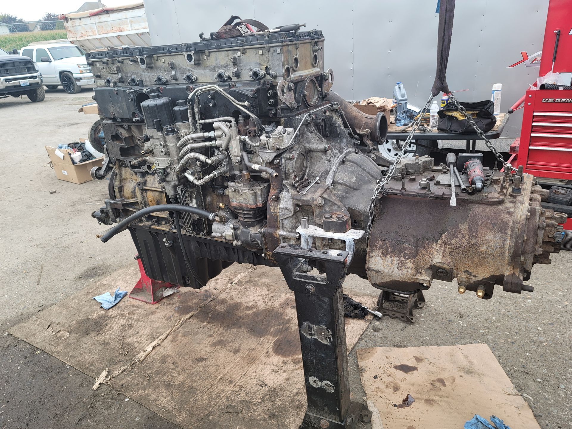 A large engine is sitting on a table in a parking lot.