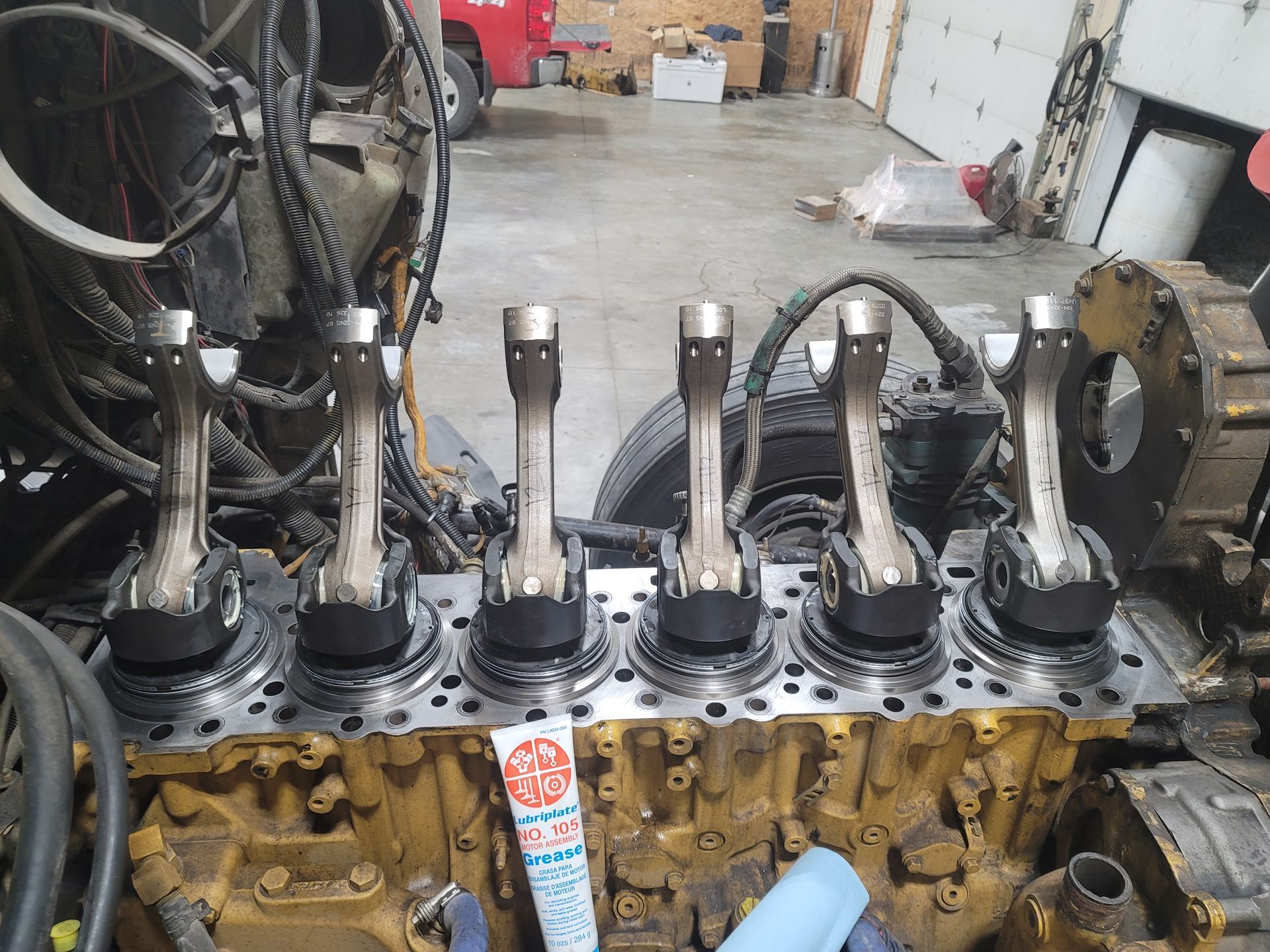 A close up of a tractor engine with pistons in it