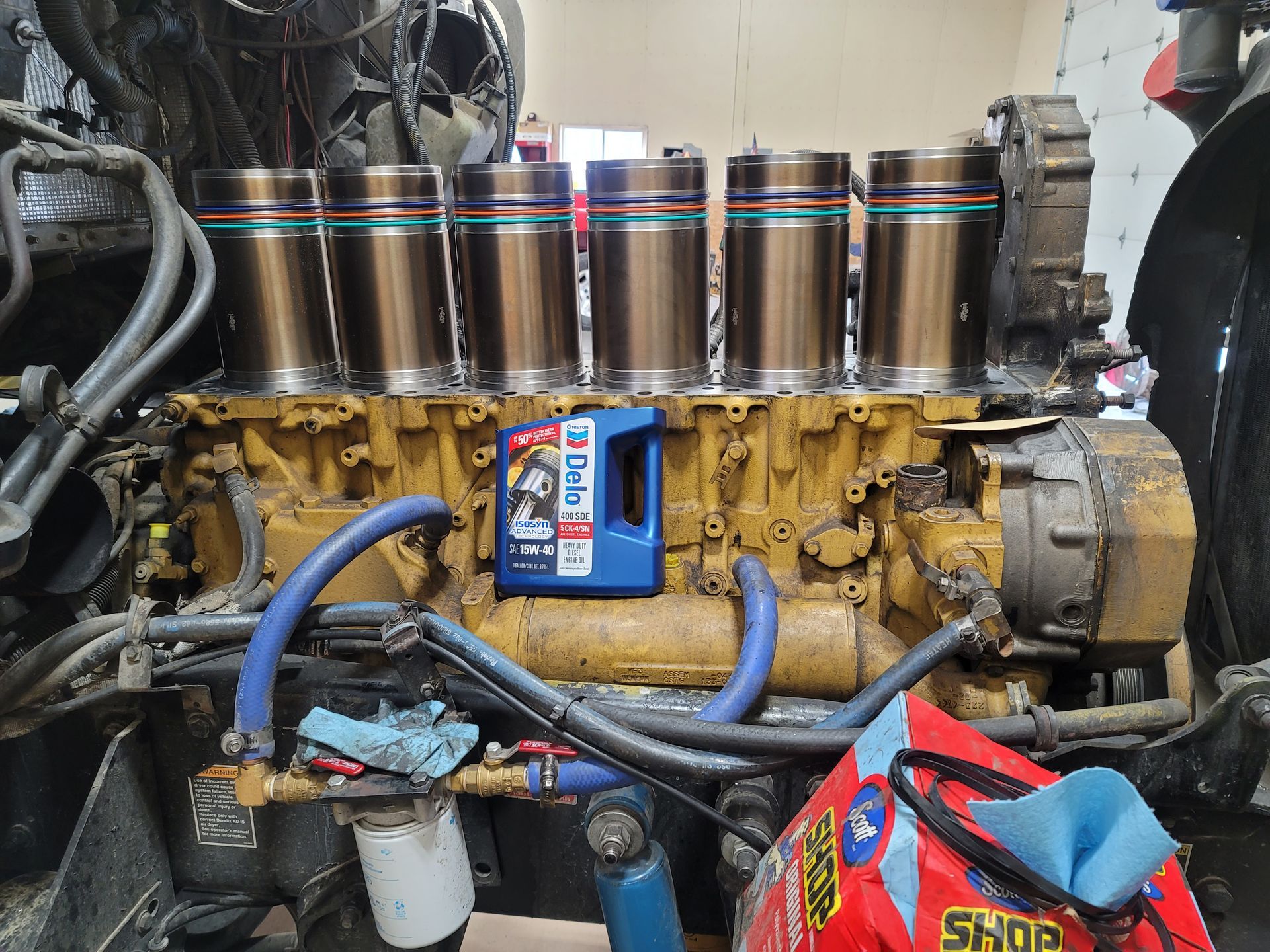 A diesel engine is being worked on in a garage.