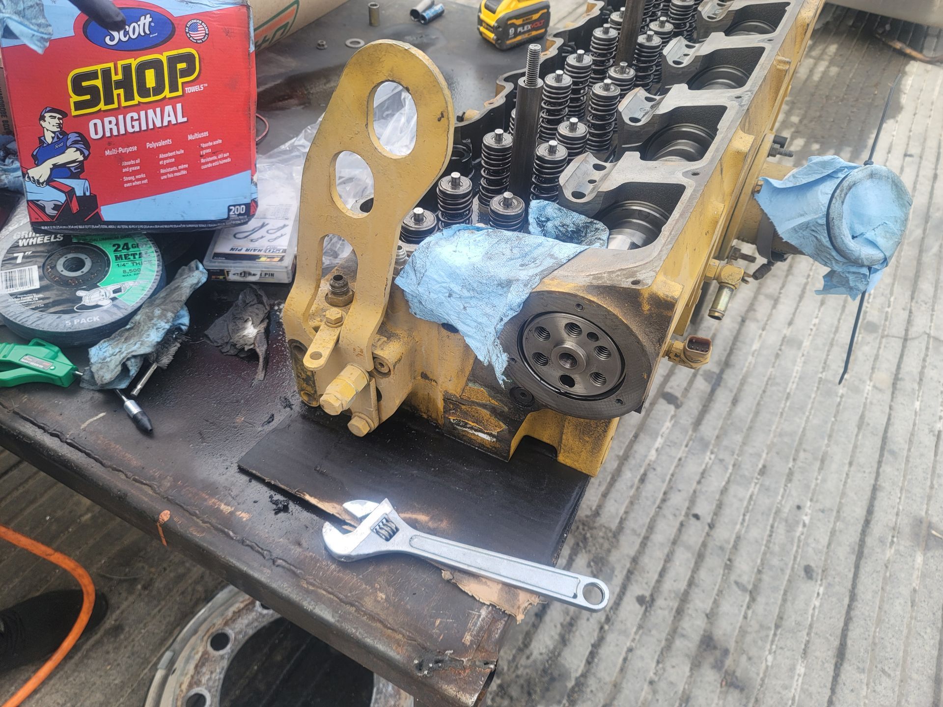 A wrench is sitting on a table next to a box of shop original.