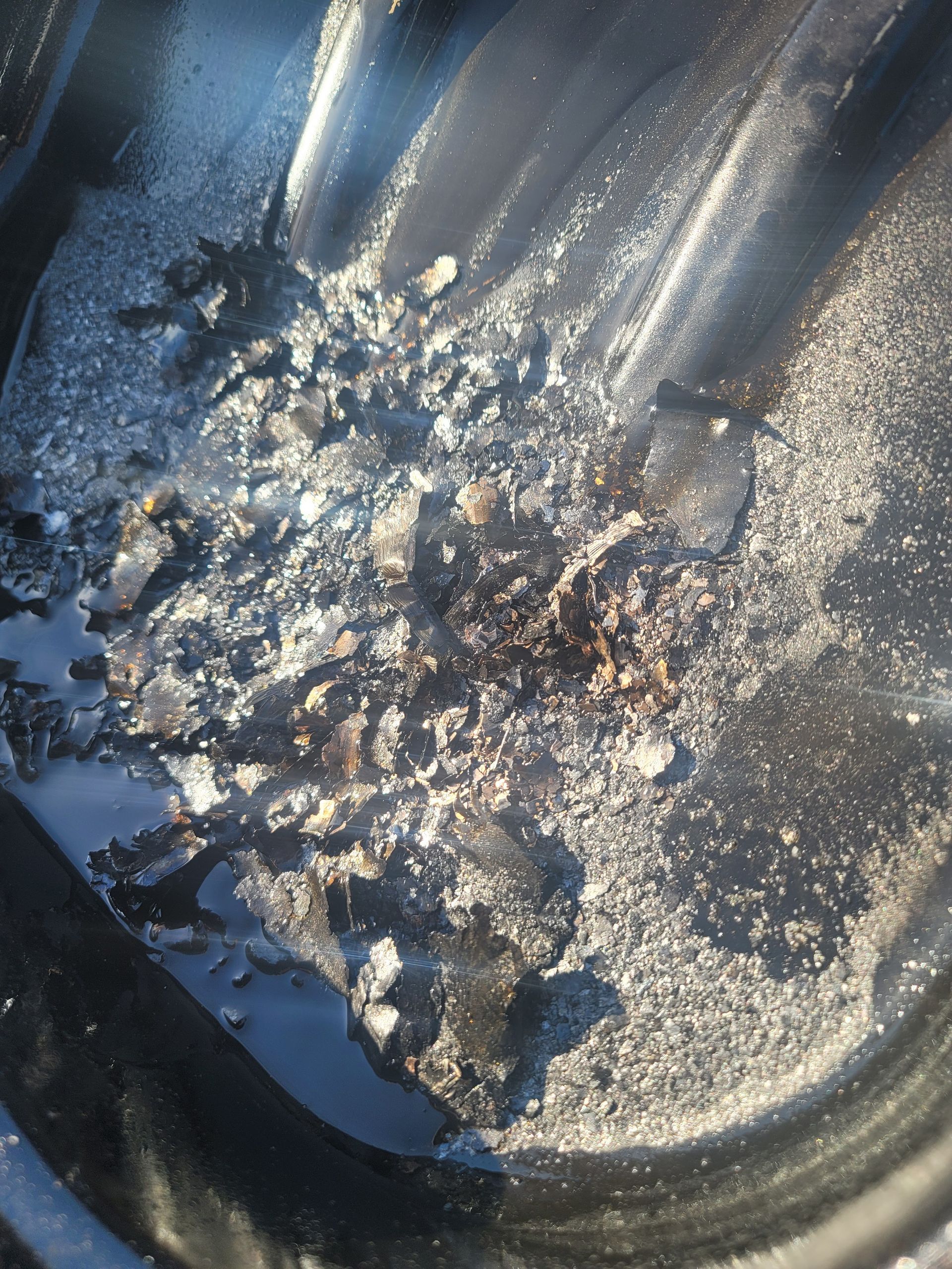 A close up of a black surface with a lot of dust on it