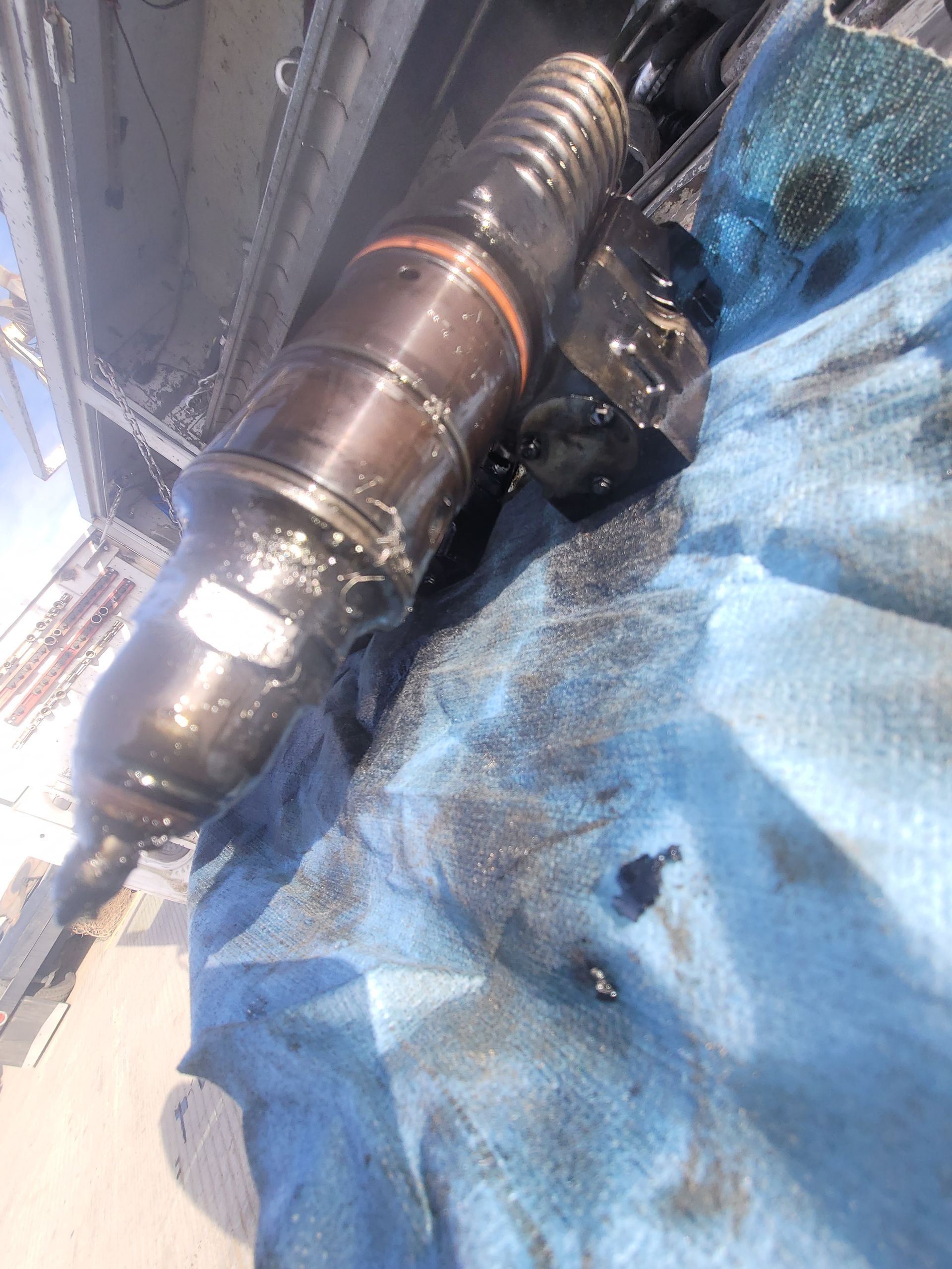 A close up of a piece of metal on a blue cloth.