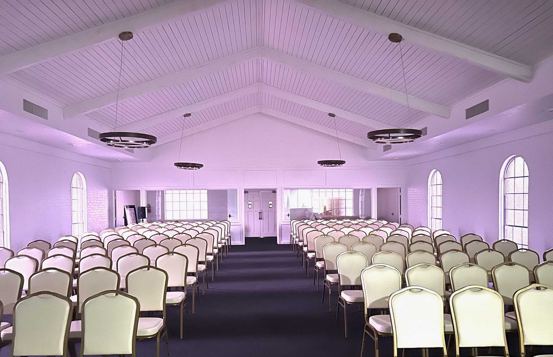 A wooden coffin with flowers on top of it in a church.