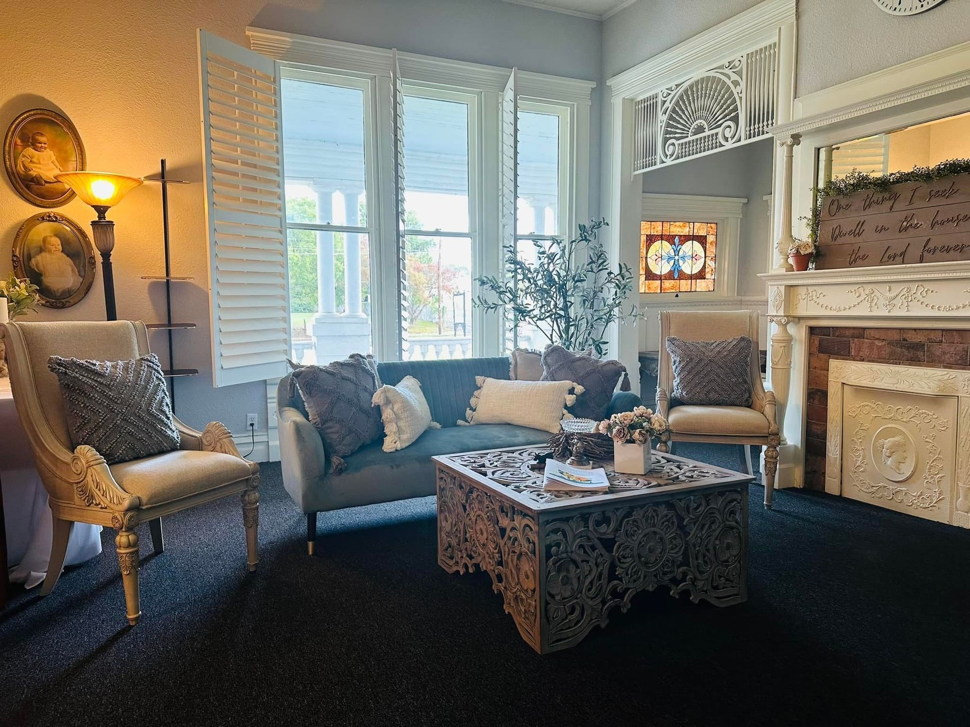 A man and a woman are sitting on a couch looking at a photo album.