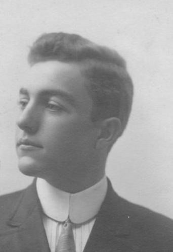 Man in suit and tie, profile view, wearing a high collar, looking left.