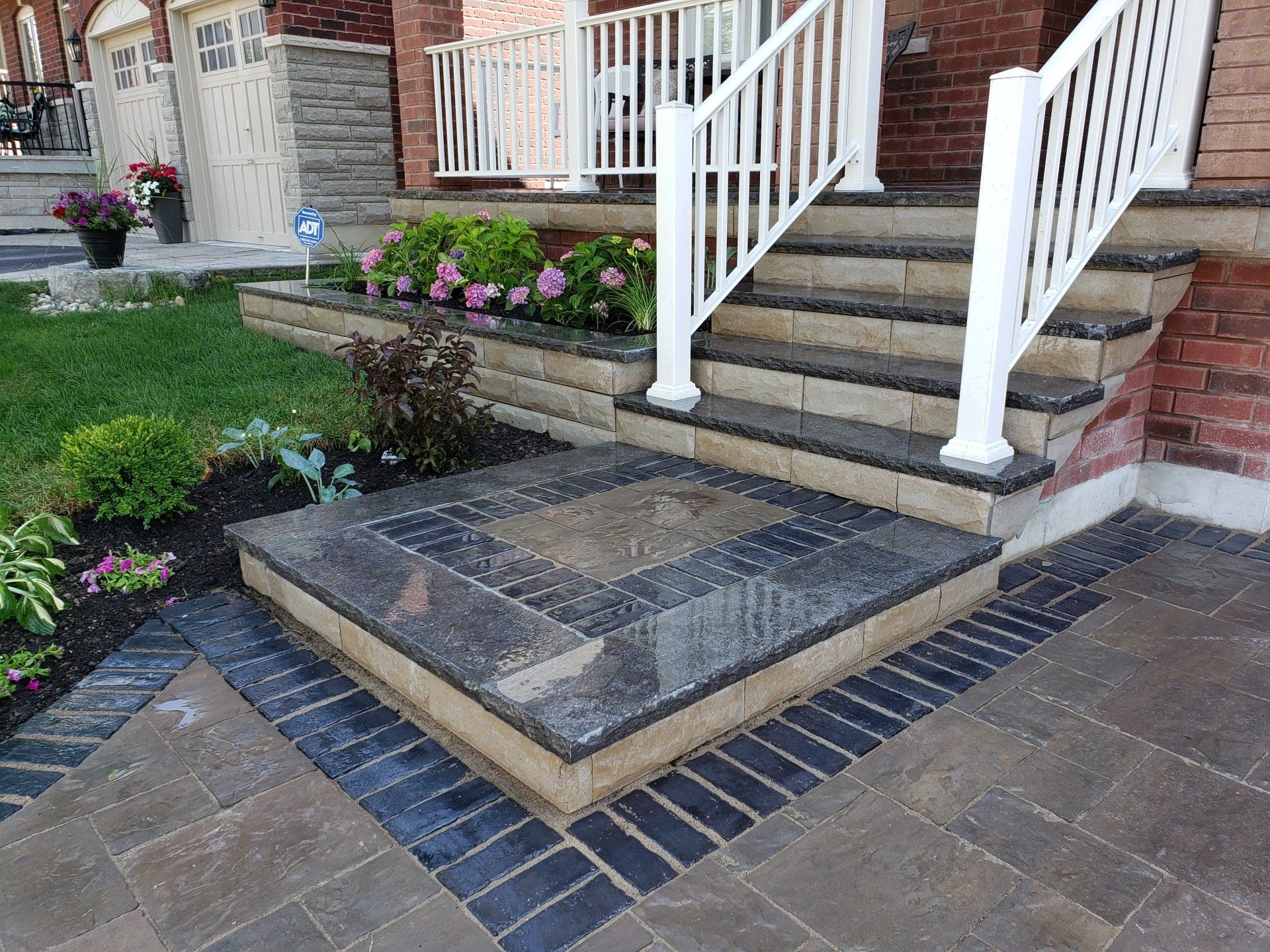 A set of stairs leading up to a house with a white railing.