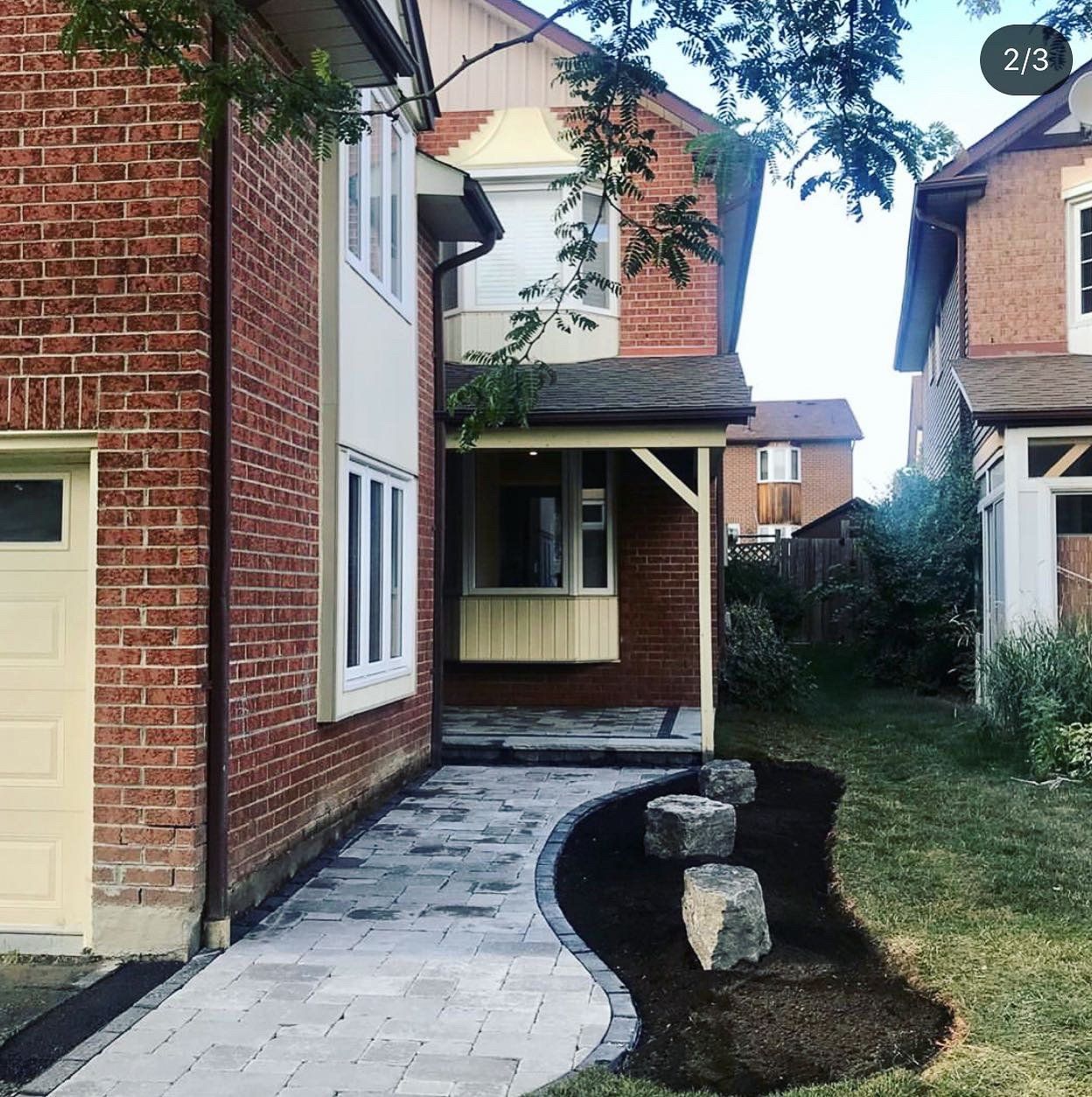 A brick house with a walkway leading to it