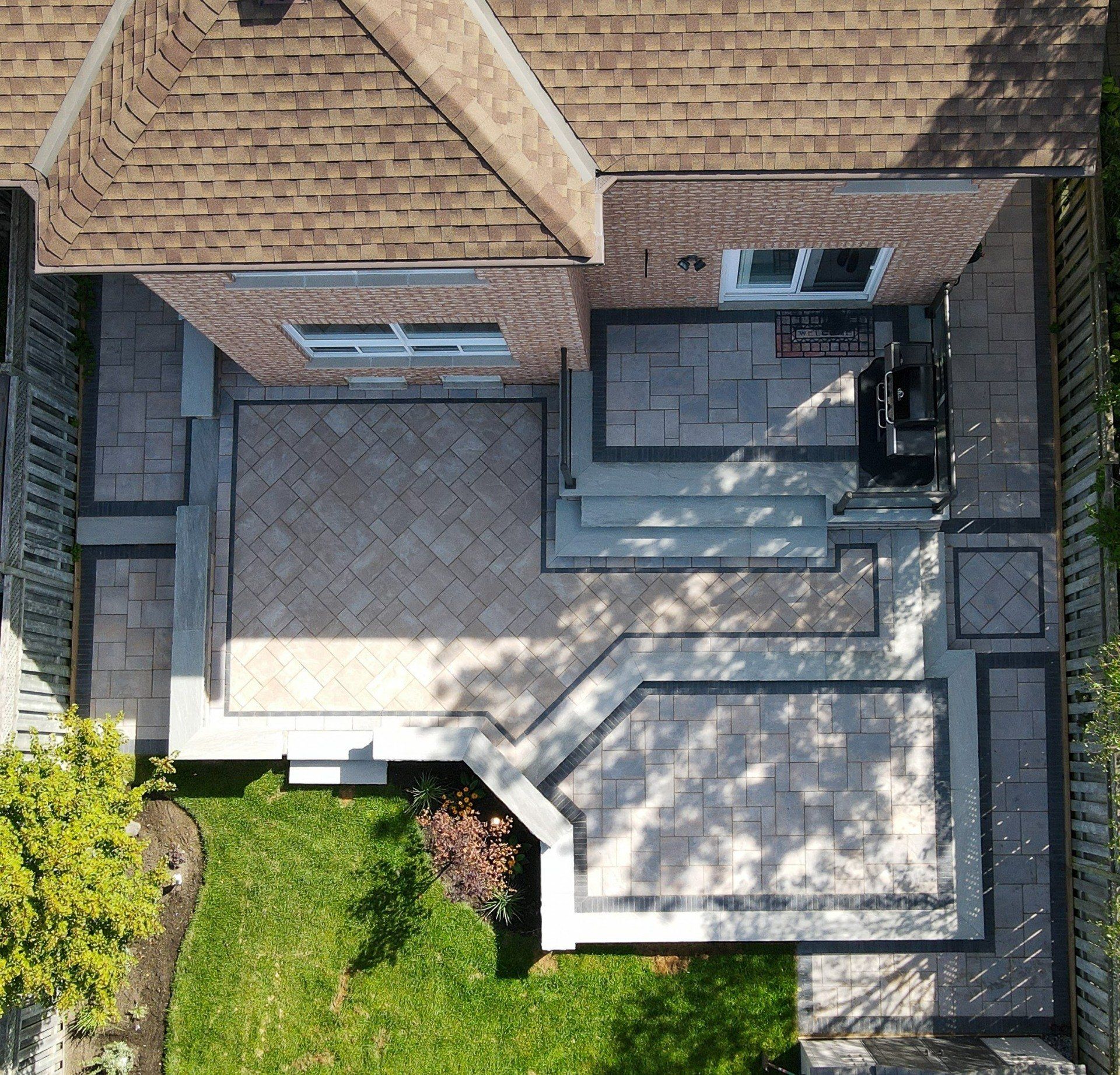 An aerial view of a brick house with a patio