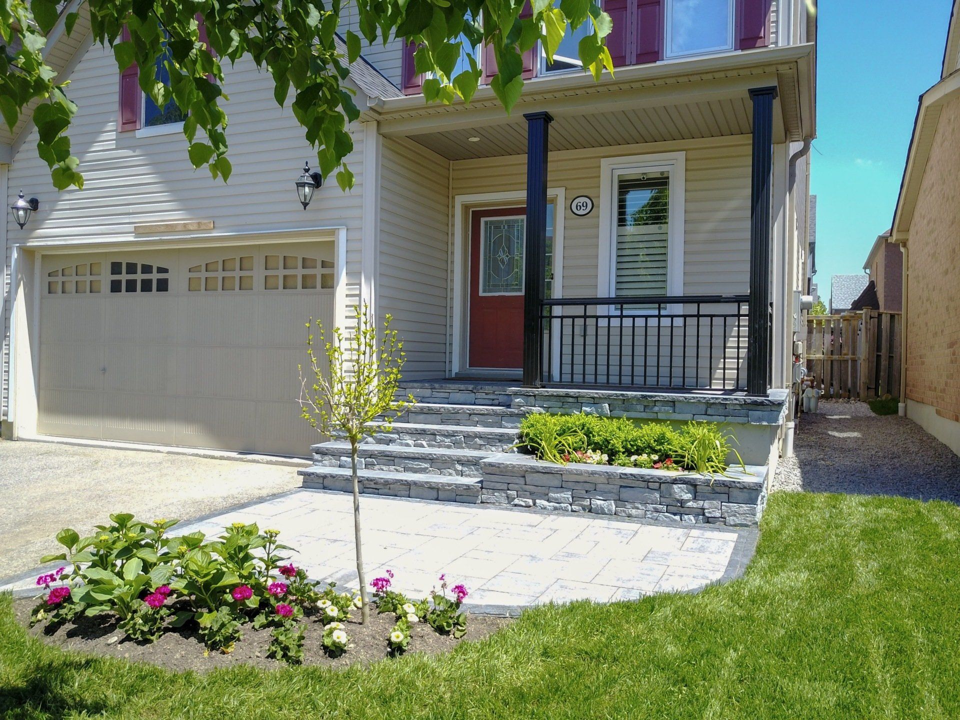 The front of a house with a red door and steps
