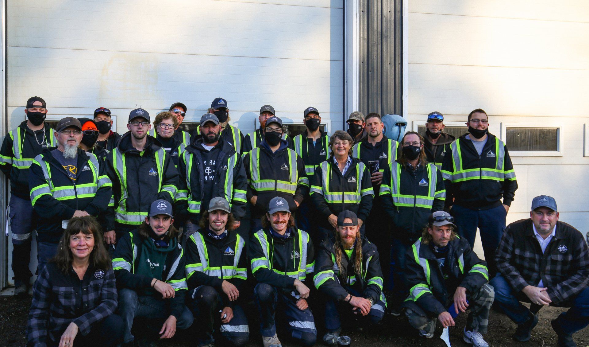 A group of people are posing for a picture in front of a building.