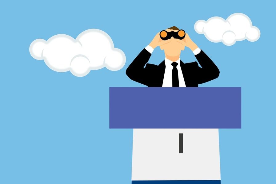 A man looking through binoculars.