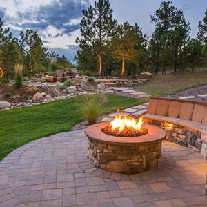 There is a fire pit in the middle of the patio.
