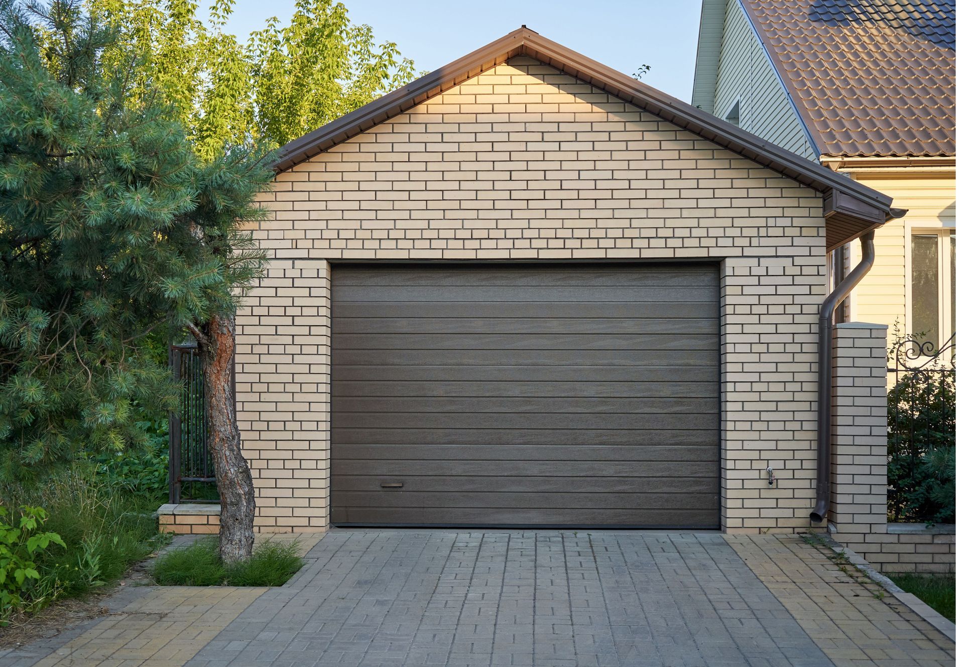 A white brick garage with a brown door
