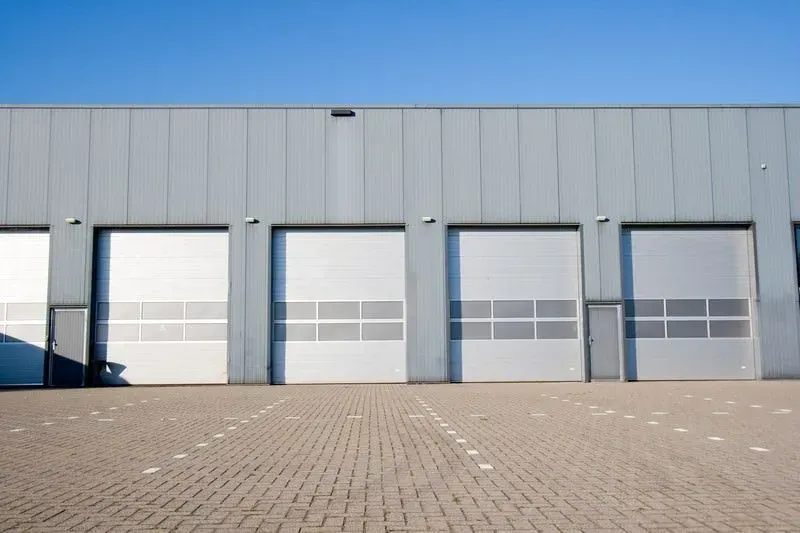 A row of garage doors on the side of a building.